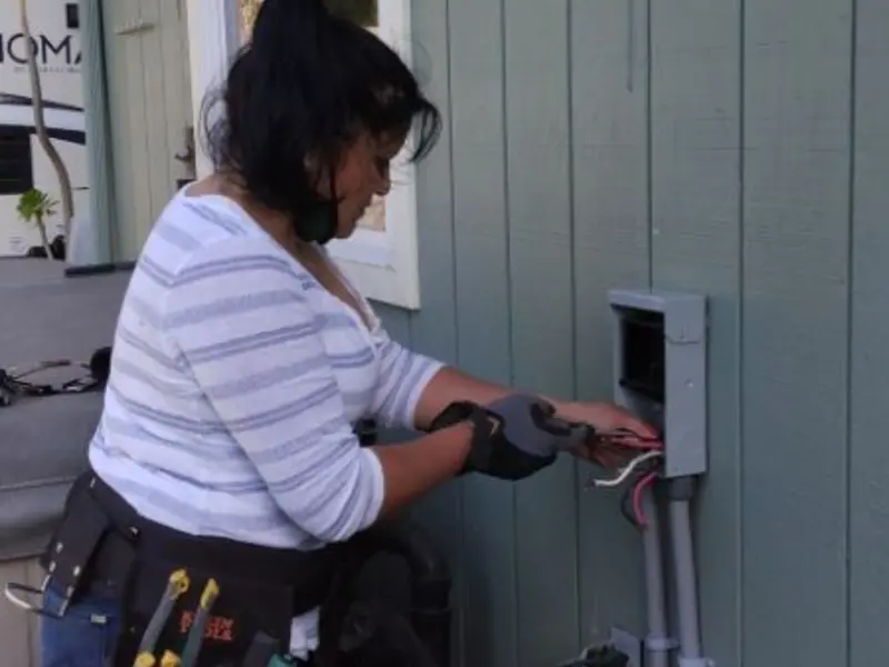 Licensed electrician wiring an exterior subpanel in Willmar