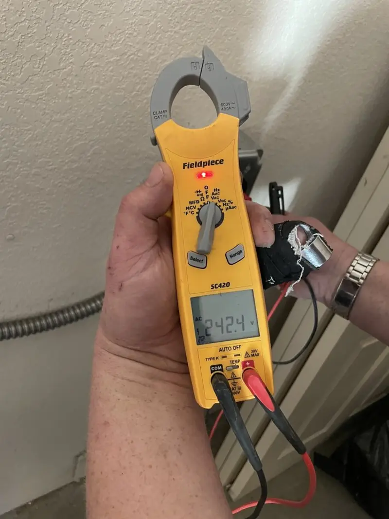 Voltage testing with clamp meter during Ceiling Fan Installation in Willmar